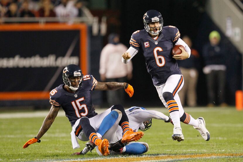 Chicago Bears quarterback Jay Cutler (6) rushes against the Detroit Lions as teammate wide...
