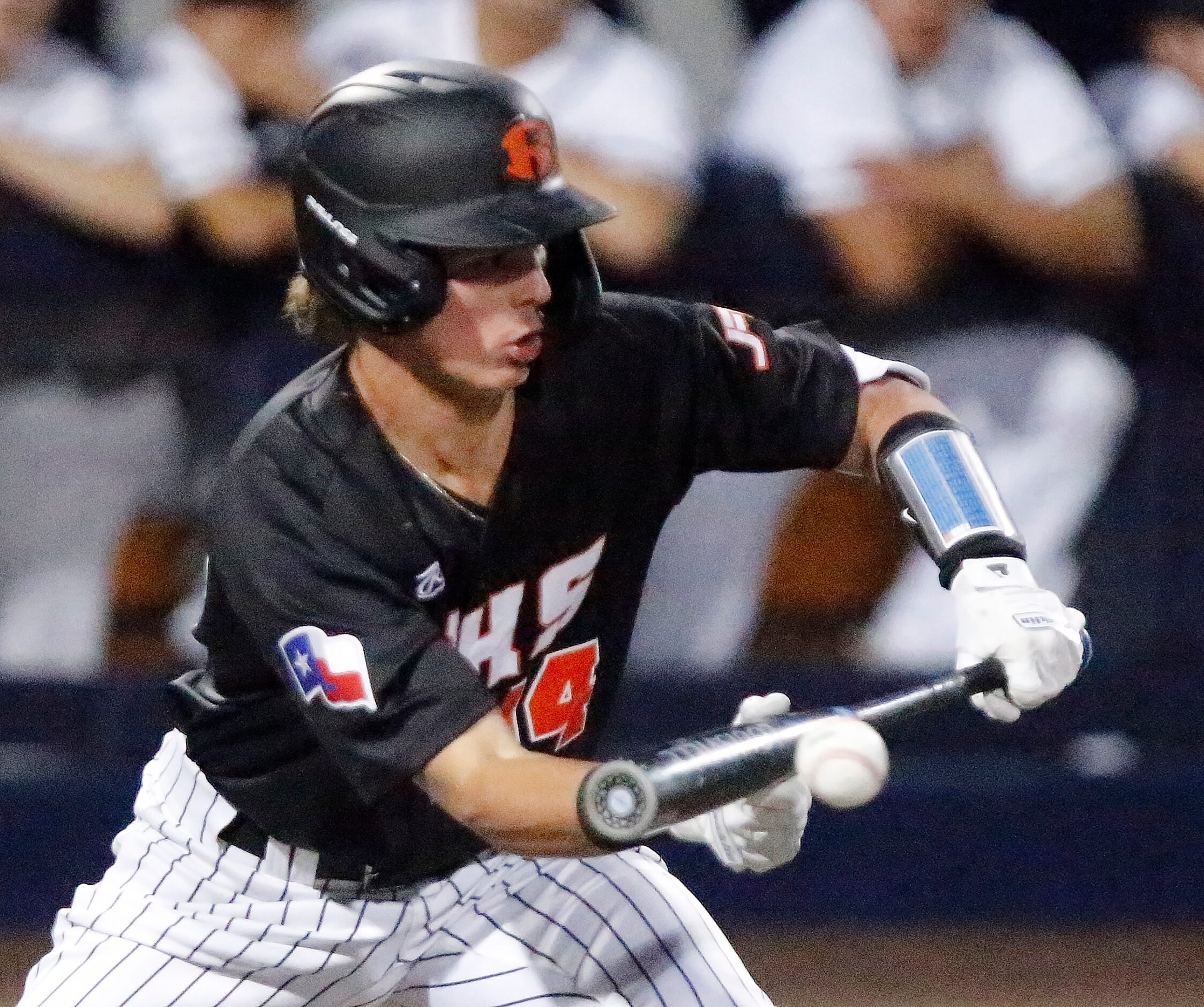 Rockwall designated hitter Tyler Rollins (14) lays down a bunt in the fifth inningh as...