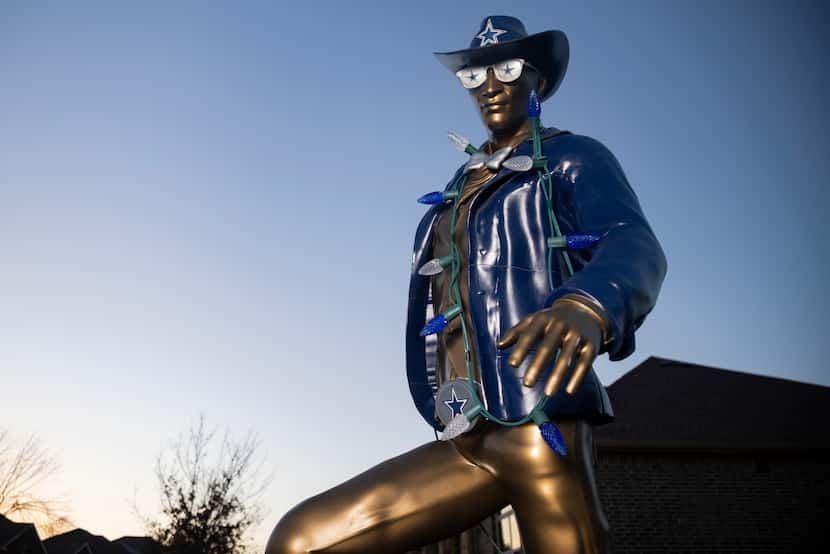 A statue of Dallas Cowboys super fan James Wright, aka Suit Man, at his home in DeSoto on...