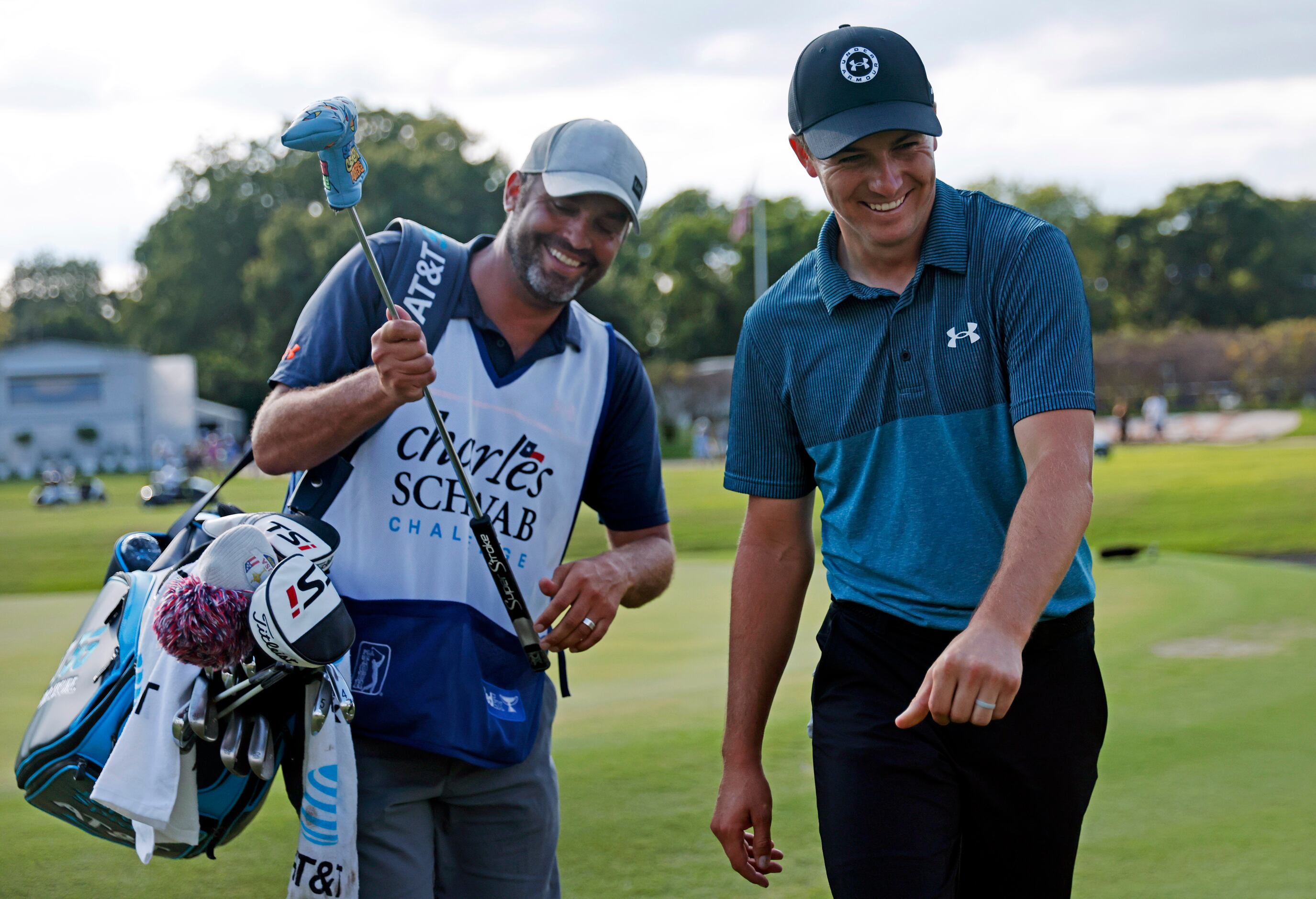 Professional golfer Jordan Spieth (right) and his caddie Michael Greller laugh as they walk...