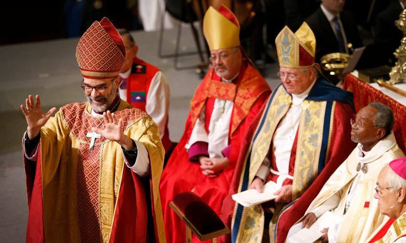 Bishop George R. Sumner acknowledges an applause during a service for the ordination and...