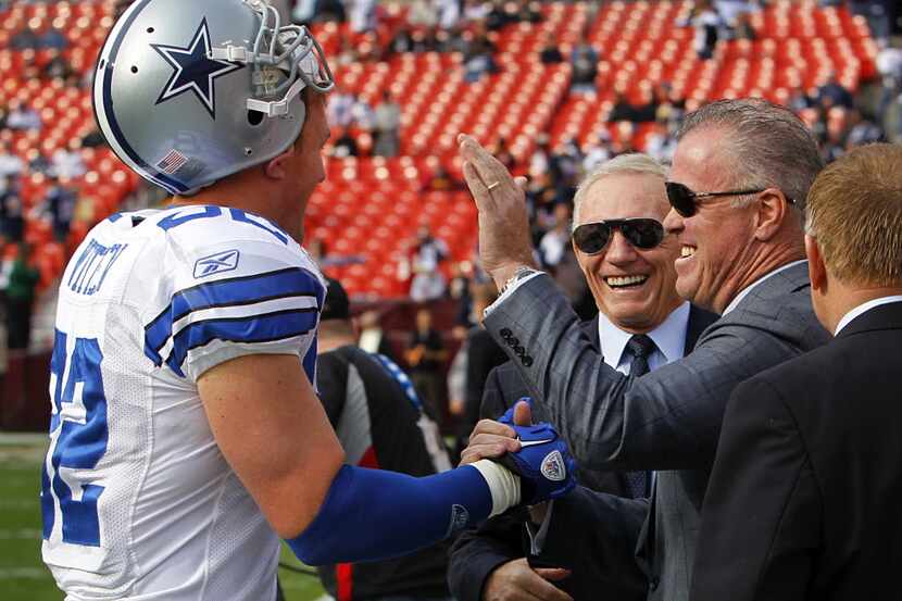 Dallas Cowboys owner Jerry Jones, center, and his son Stephen Jones, right joke with tight...