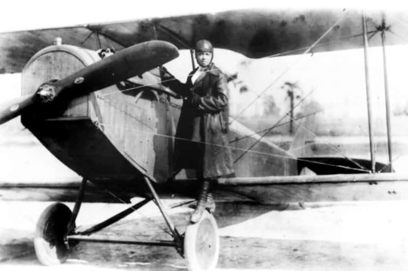 Pioneer aviator Bessie Coleman stands on the wheel of a plane in this 1920s photo. Coleman...