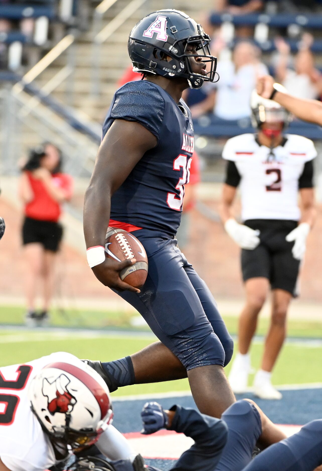 Allen's DJ Hicks (30) reacts after running for a touchdown in the first half of a high...