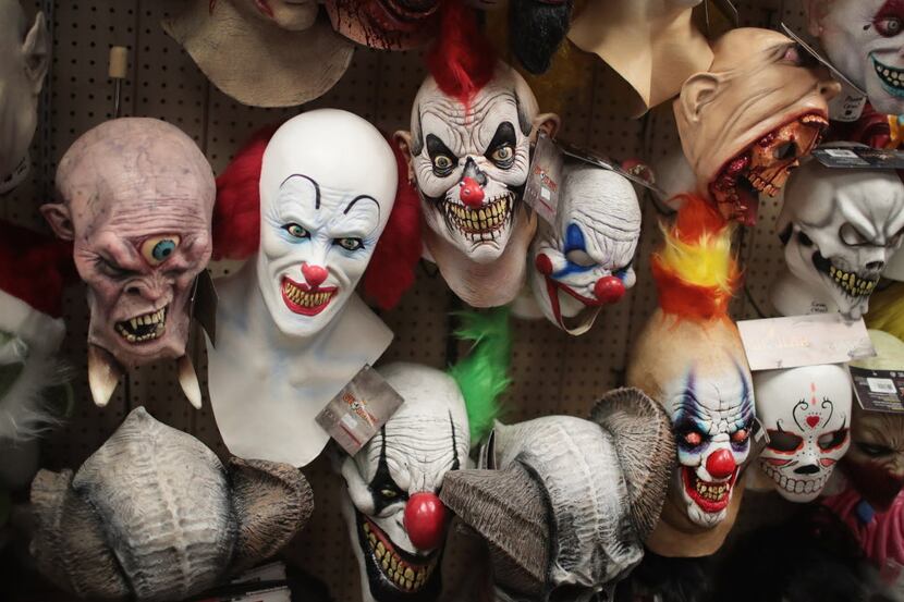 Halloween masks are offered for sale at Fantasy Costumes in Chicago.  Although at least one...