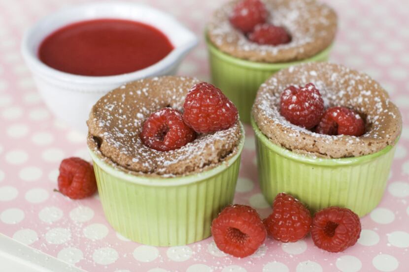 In this image taken on Jan. 21, 2013, warm double chocolate cakes with raspberry sauce are...