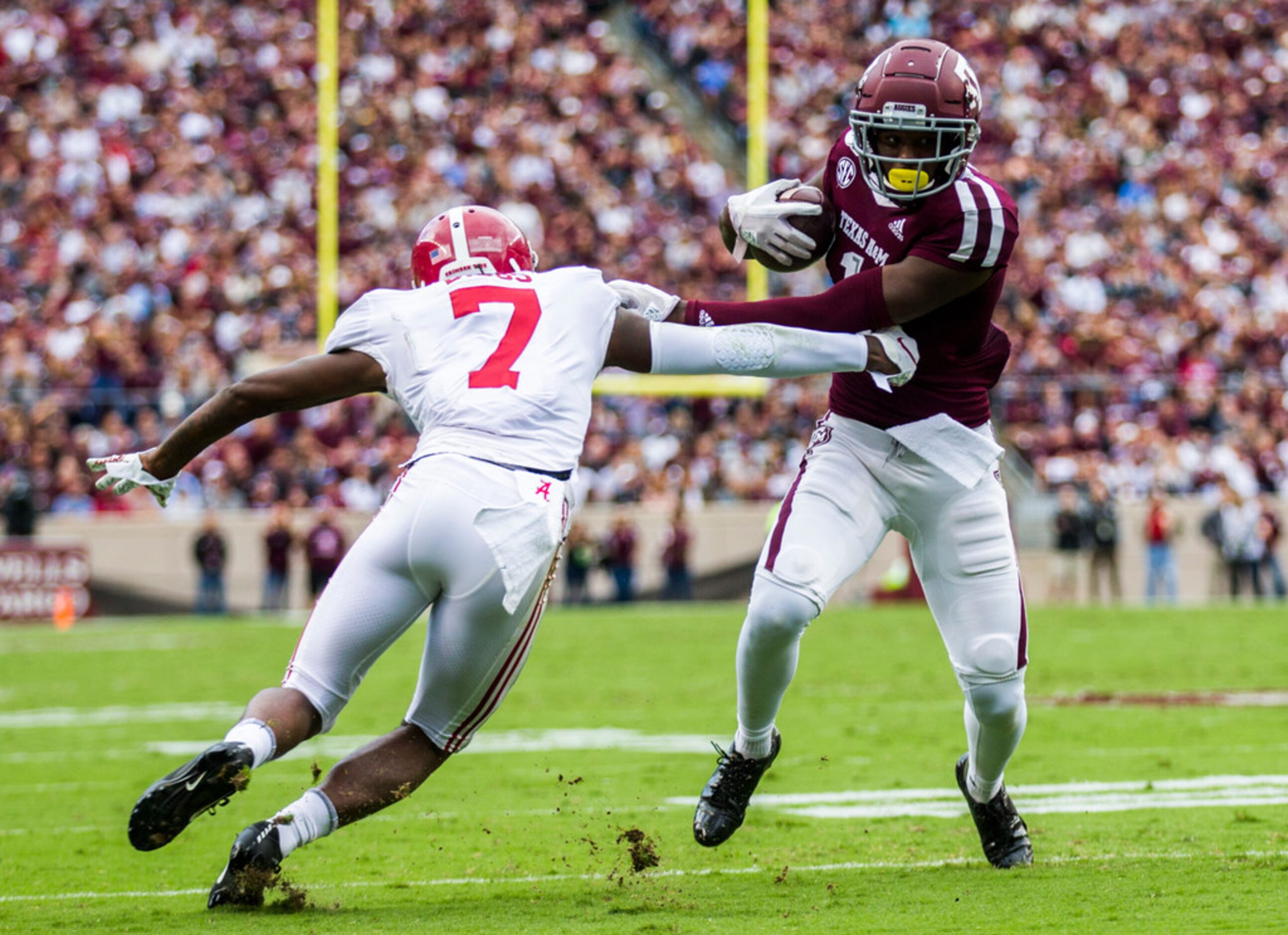 Texas A&M Aggies wide receiver Quartney Davis (1) fends off Alabama Crimson Tide defensive...