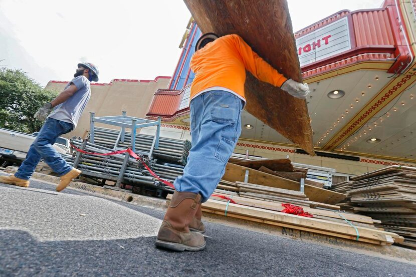 As Rufino Lopez  (center) and Patrick Moreno (left) moved the scaffolding, theater owner...