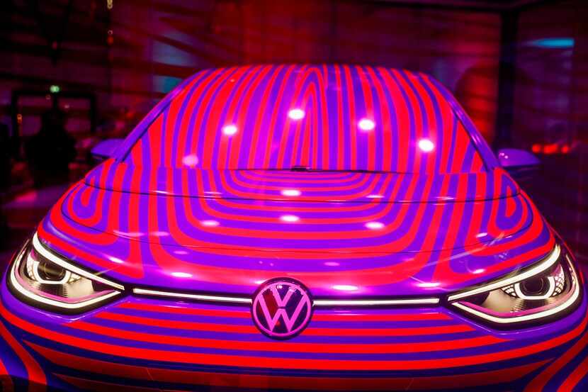 A Volkswagen ID 3 electric car is seen in a glass cage during a press conference in Berlin...