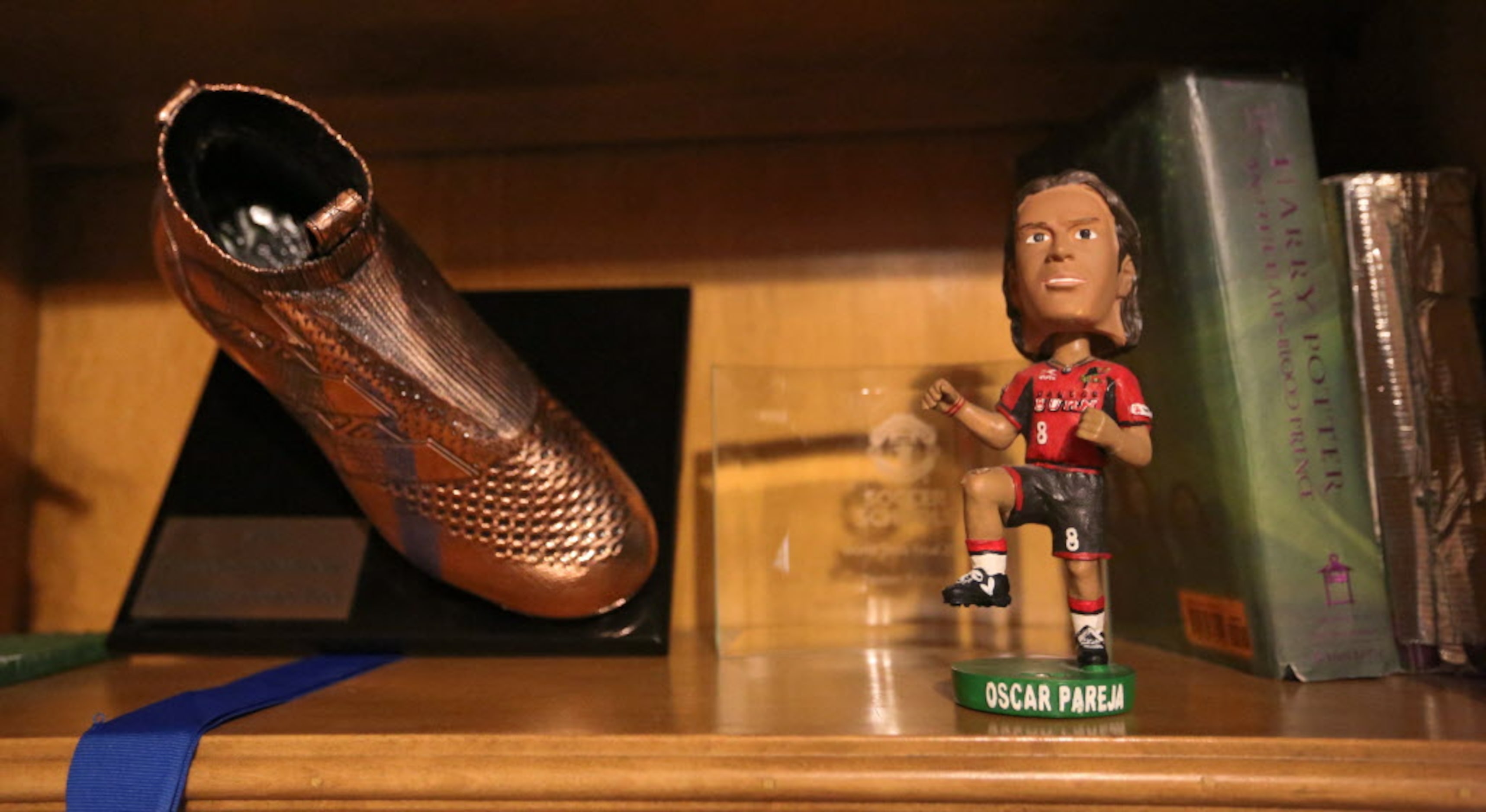 Some of the memorabilia of Paxton Pomykal, including a bobblehead of his FC Dallas coach. is...