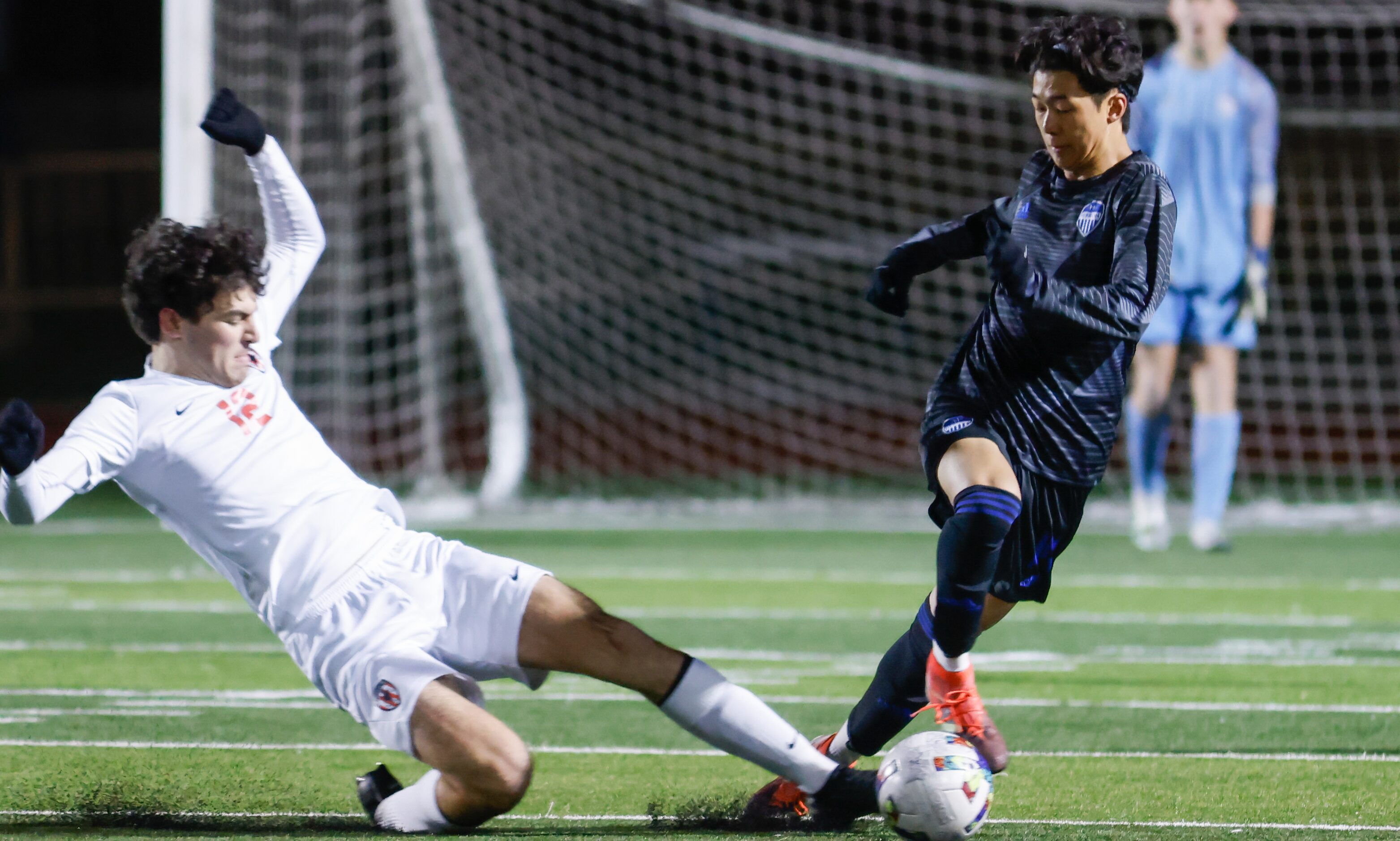 Flower Mound Marcus’ Mason McIntosh (12) slides to make contact with the ball in Hebron’s...