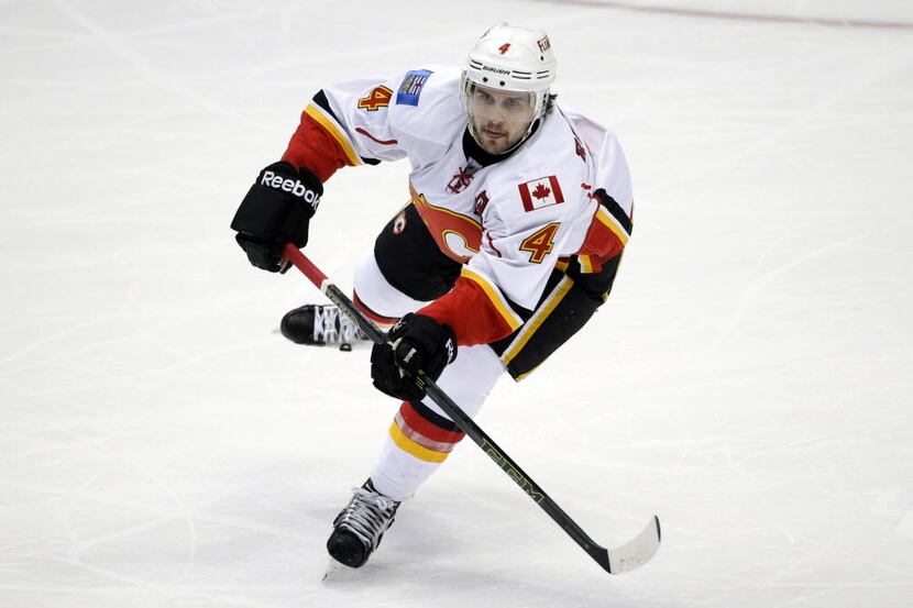FILE - In this Nov. 24, 2015, file photo, Calgary Flames' Kris Russell moves the puck during...