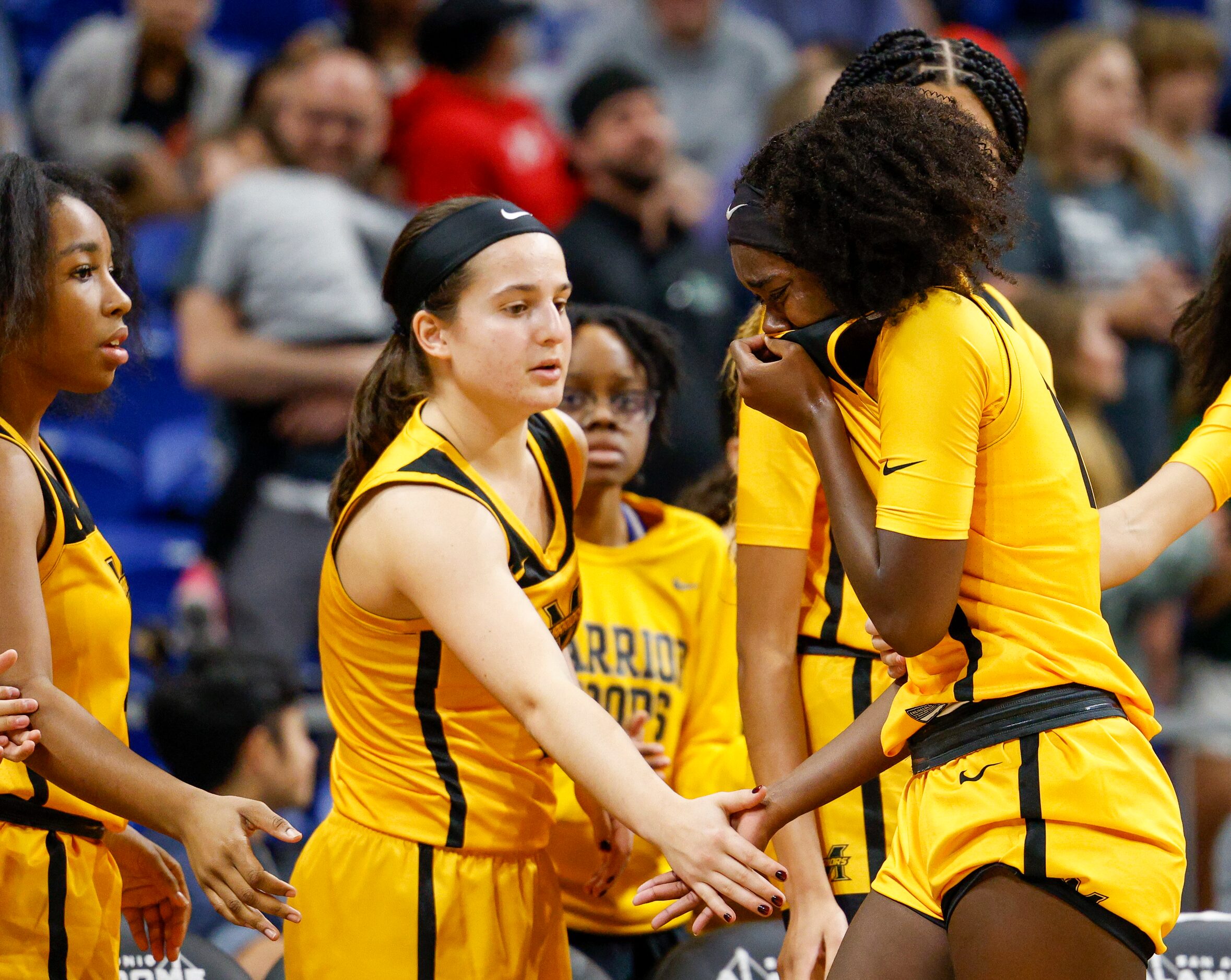 Frisco Memorial guard Jasmyn Lott (10) is greeted by Frisco Memorial guard Natalie Gheisar...