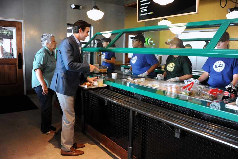 Guests order sides in the buffet style line at the new Ten 50 BBQ in Richardson.