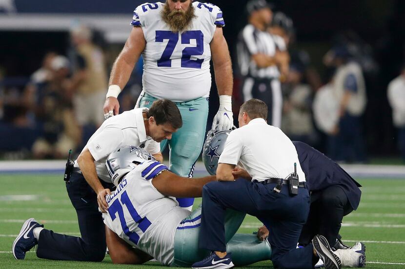 Dallas Cowboys offensive tackle La'el Collins (71) is tended to by the medical team as...