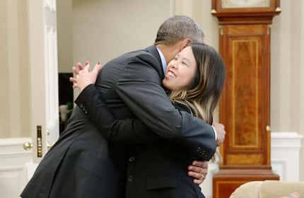 President Barack Obama gives a hug to Dallas nurse Nina Pham in the Oval Office of the White...