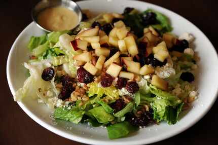The Autumn Harvest Salad features romaine and butter lettuce, apples, feta, and dried...