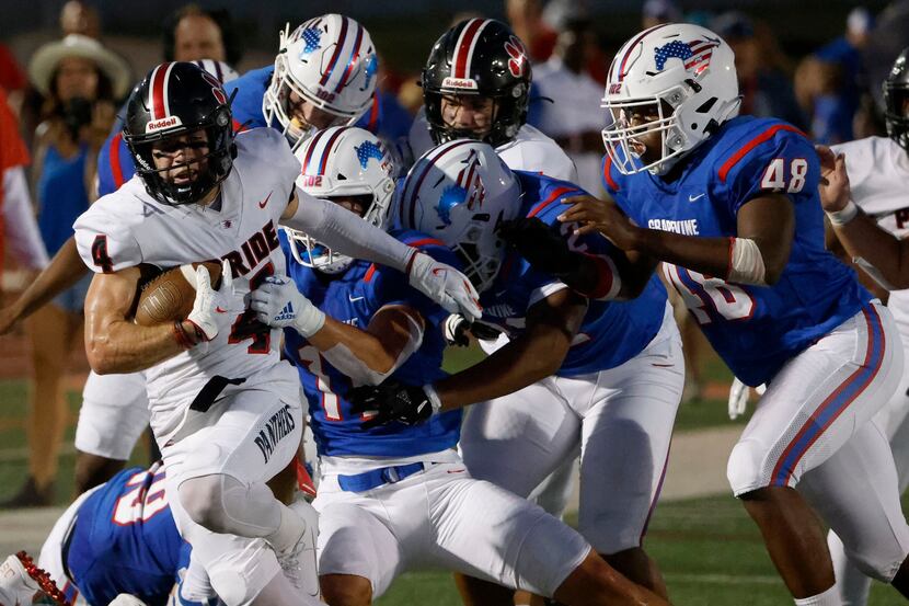 Grapevine defenders, including Brannan Mannix (11) try to tackle Colleyville Heritage...
