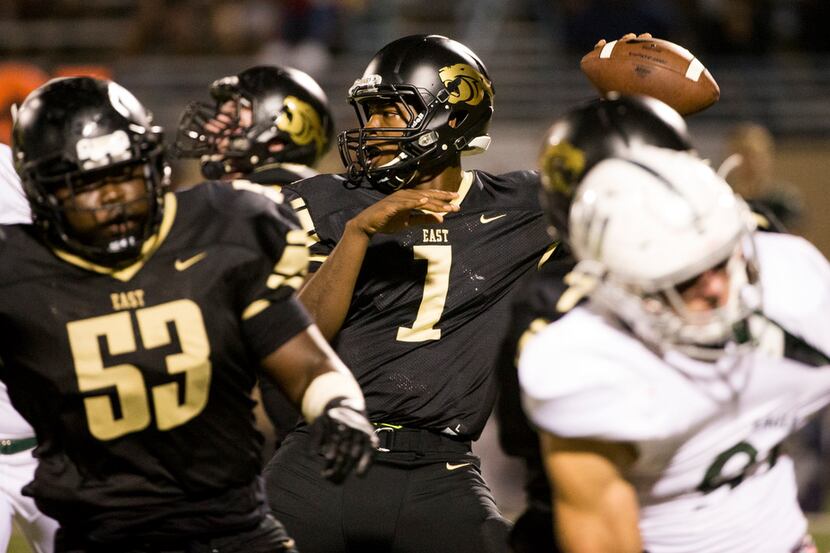 Plano East quarterback Brandon Mallory (1) looks to make a pass during a football game...