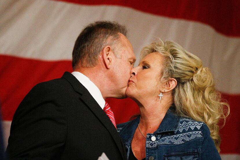 Former Alabama Chief Justice and U.S. Senate candidate Roy Moore, greeted his wife, Kayla...