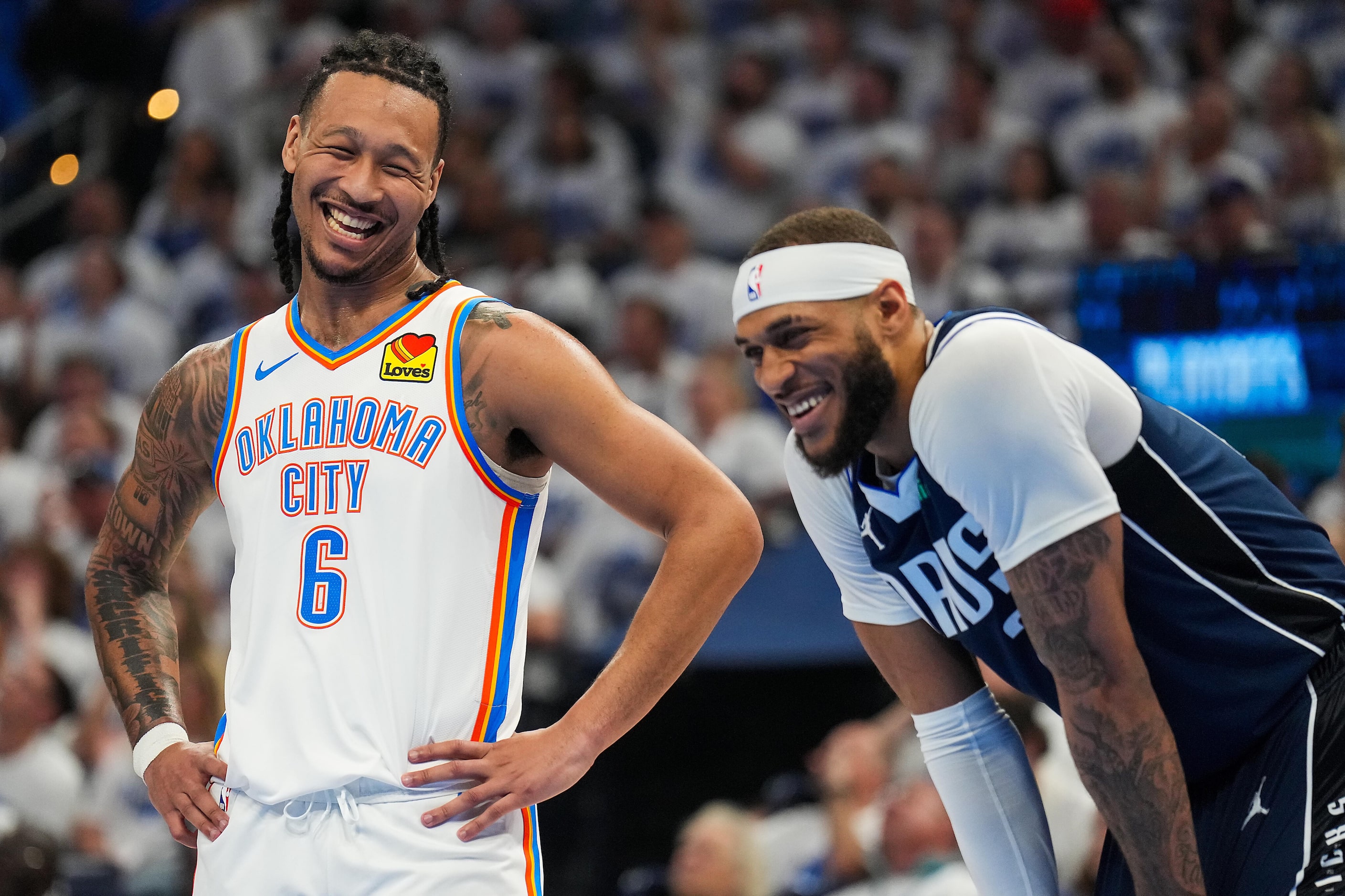 Oklahoma City Thunder forward Jaylin Williams (6) laughs with Dallas Mavericks center Daniel...