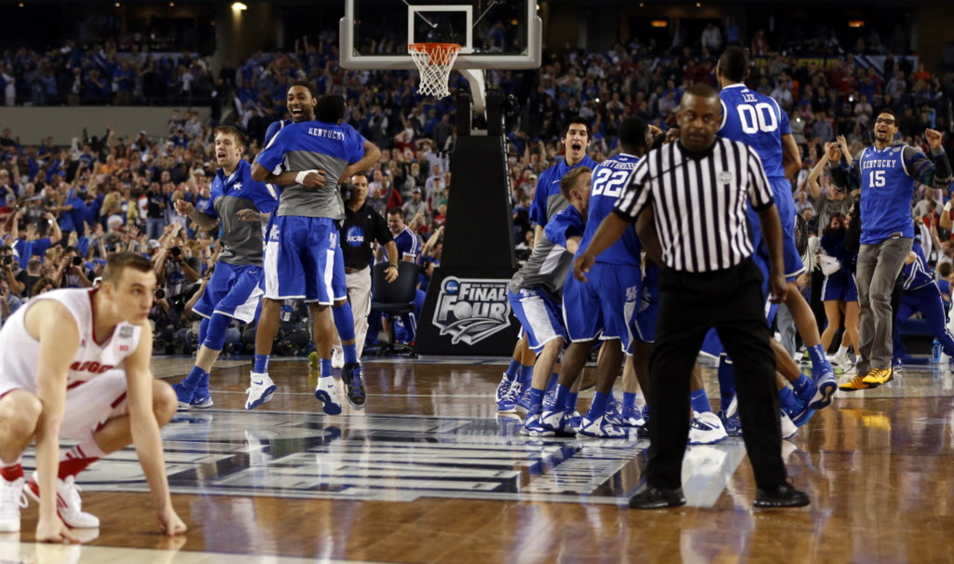 Kentucky Wildcats celebrates as Wisconsin Badgers looks dejected during the second half of a...