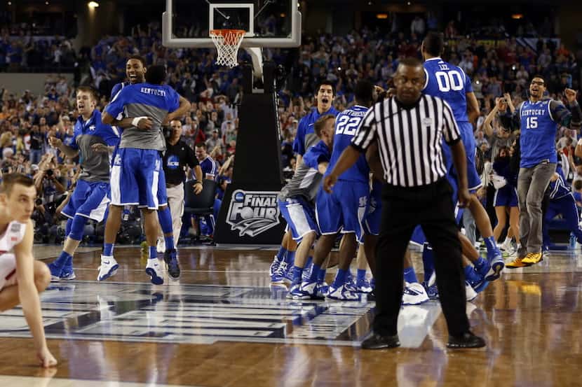 Kentucky Wildcats celebrates as Wisconsin Badgers looks dejected during the second half of a...