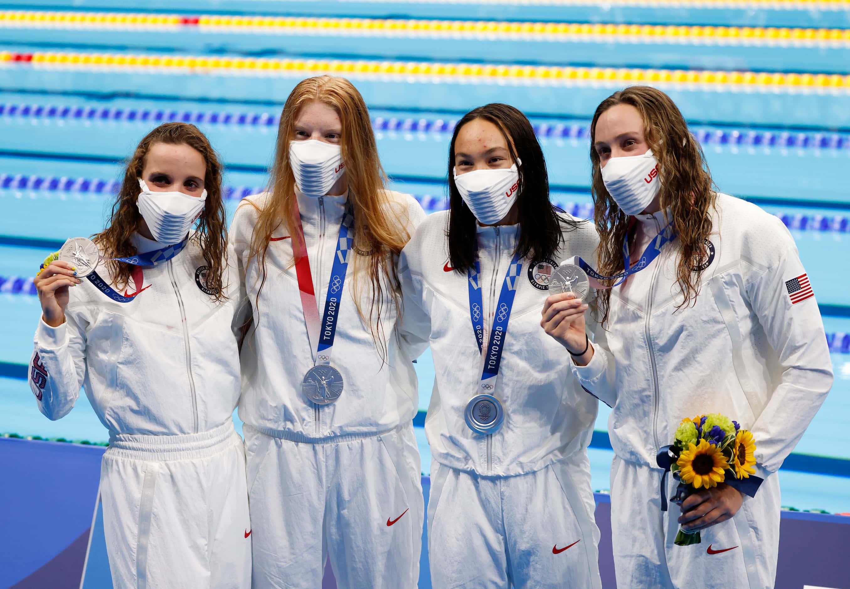 USA’s Regan Smith, Lydia Jacoby,  Torri Huske, and Abbey Weitzeil pose for photos after...