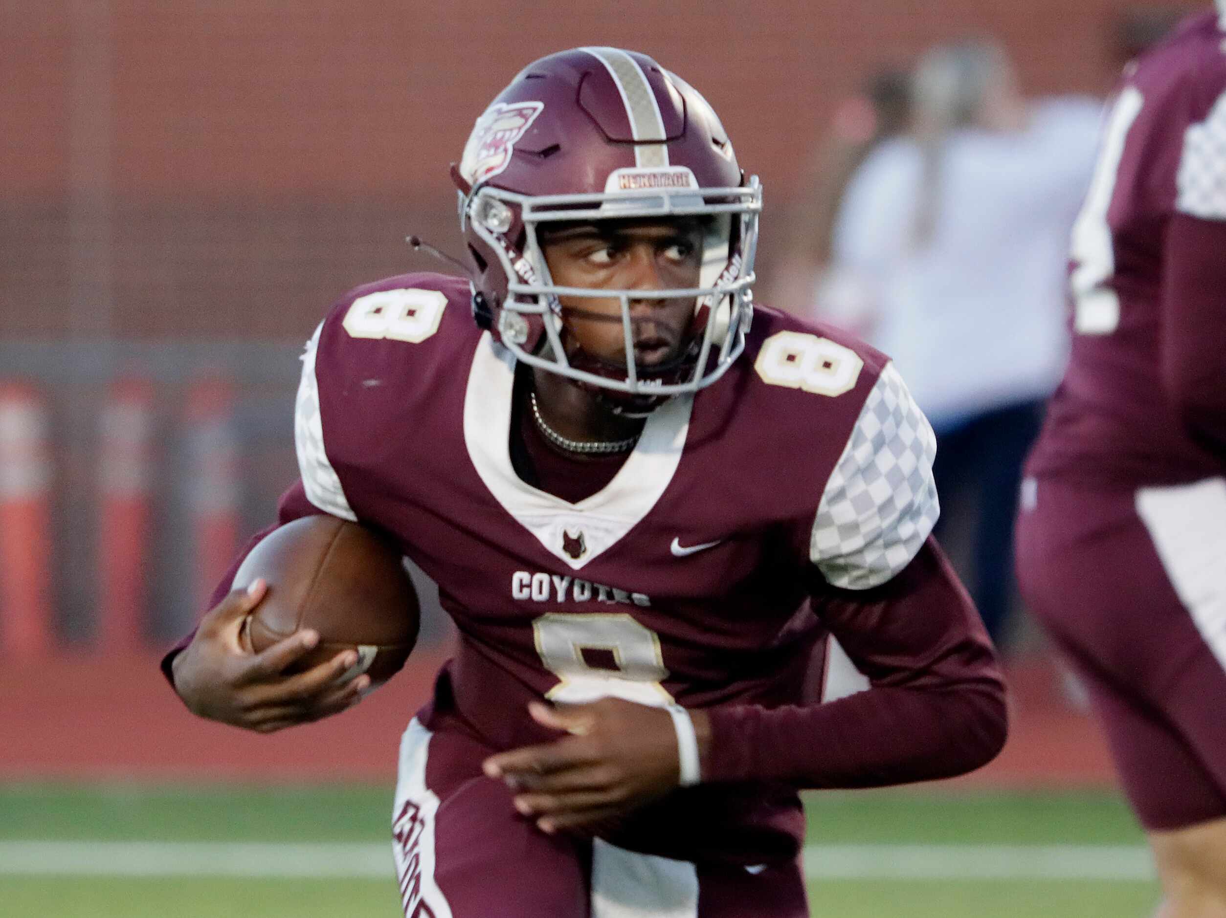 Frisco Heritage High School quarterback Jiyere Cogshell (8) carries the football during the...