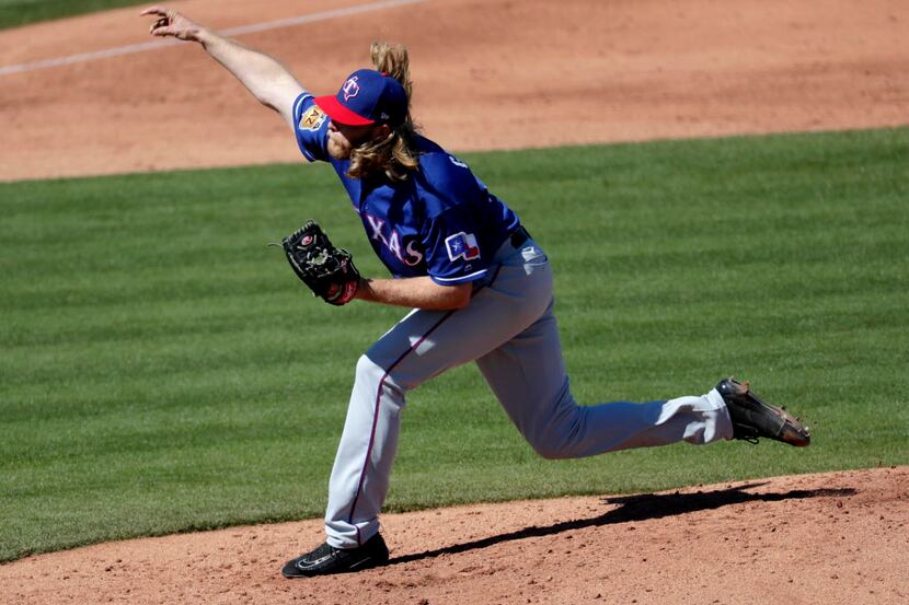 Texas Rangers starting pitcher A.J. Griffin throws against the Seattle Mariners during the...