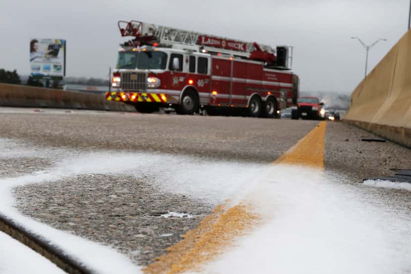 Ice covered part of the overpass of U.S. Highway 67 over Hampton Road in Dallas on Sunday....