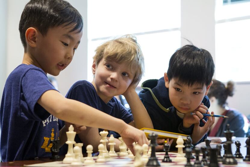 From left: Benjamin Kwon, Davin Friedman and Cooper Reid Dong review a position from a...