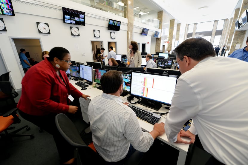 Journalists work in the main newsroom area of the new Al Jazeera America television...