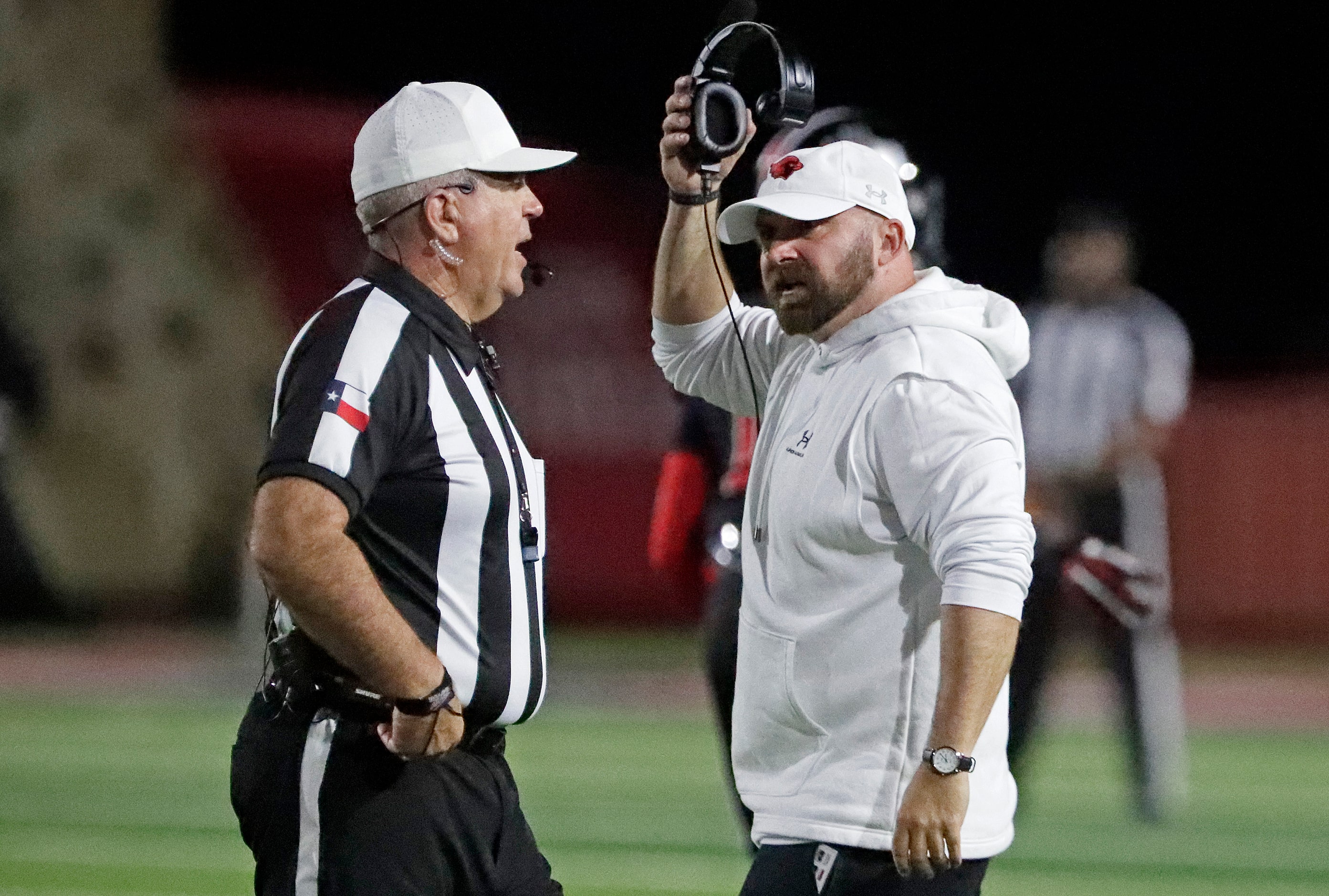 Melissa High School head coach Matthew Nally (right) asks for clarification during the first...