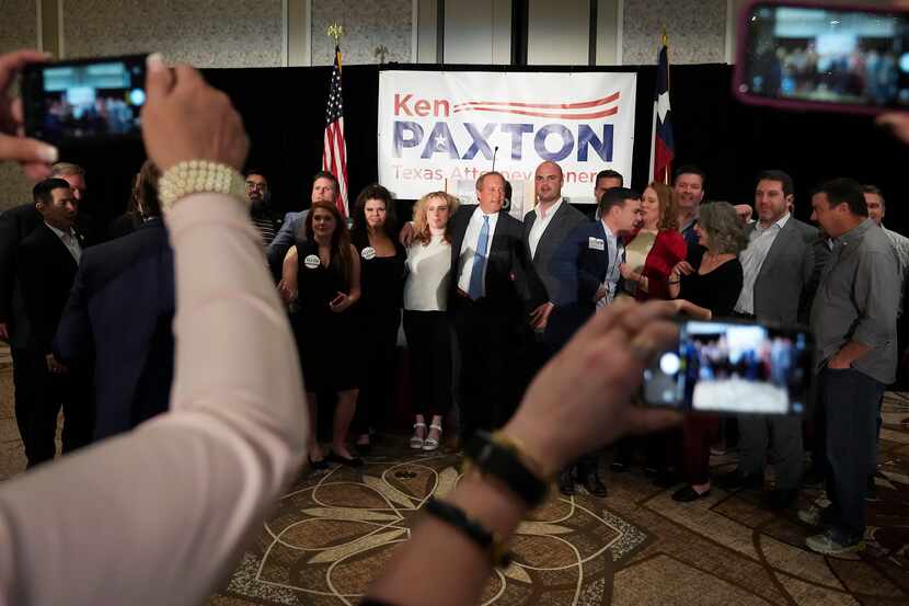 Texas Attorney General Ken Paxton poses for a photo with supporters during a primary...