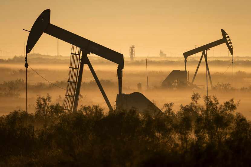 Fog blankets a low-lying area where pumpjacks operate in West Texas, northeast of Kermit, on...