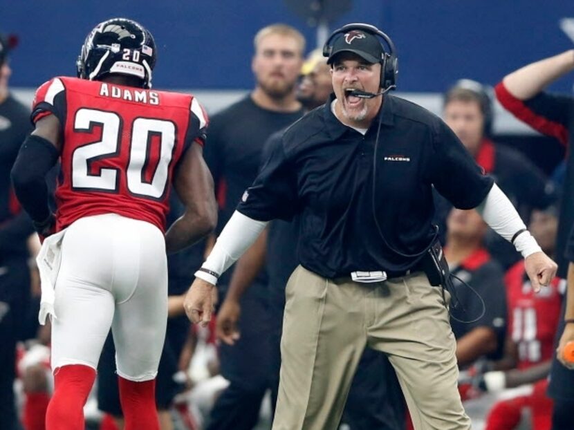 Atlanta Falcons head coach Dan Quinn celebrates after his defense sacked Dallas Cowboys...