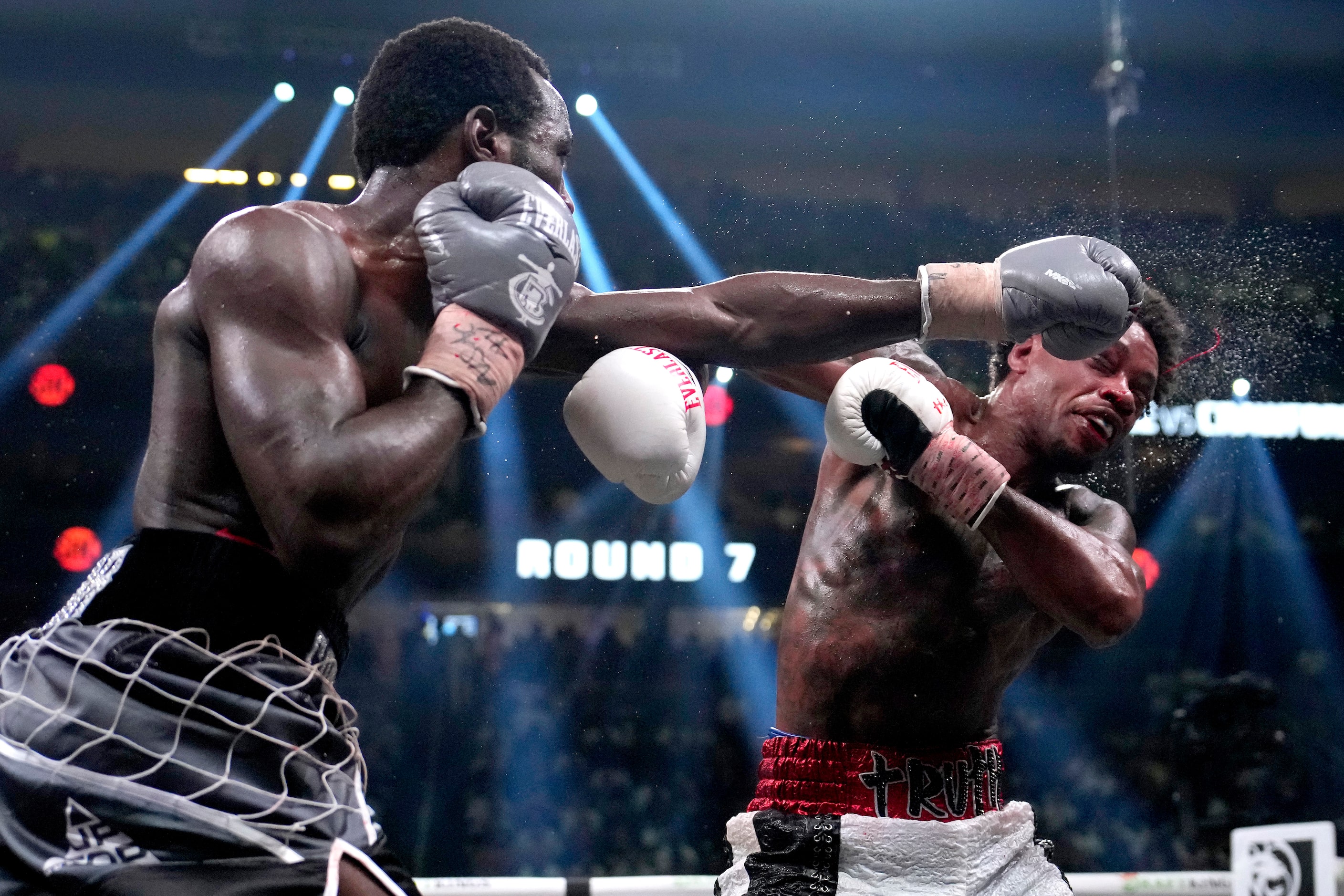 Terence Crawford, left, hits Errol Spence Jr. during their undisputed welterweight...