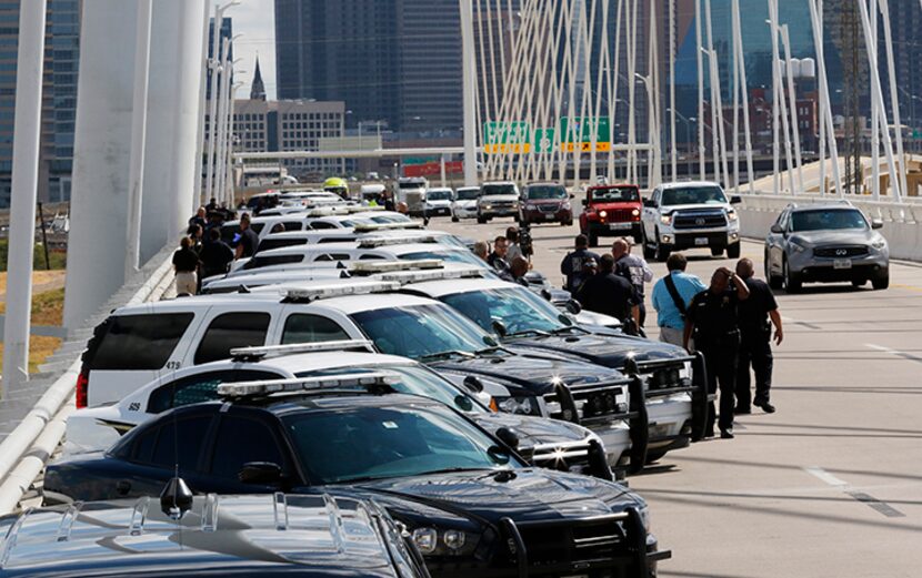  Dallas Sheriff's Department squads lined up about 50 vehicles on the Margaret Hunt Hill...