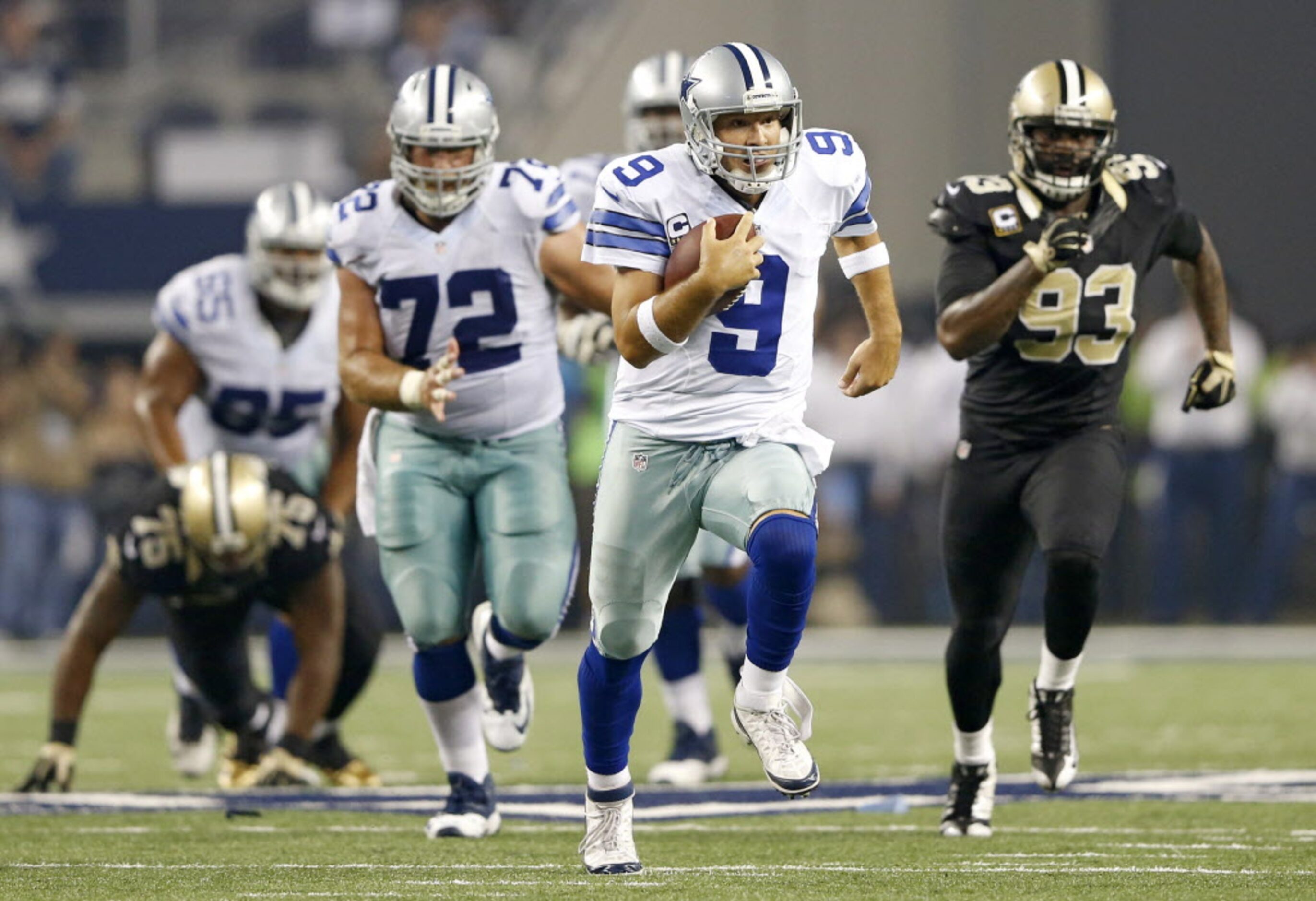 Dallas Cowboys quarterback Tony Romo (9) rushes up the field for a first down in a game...