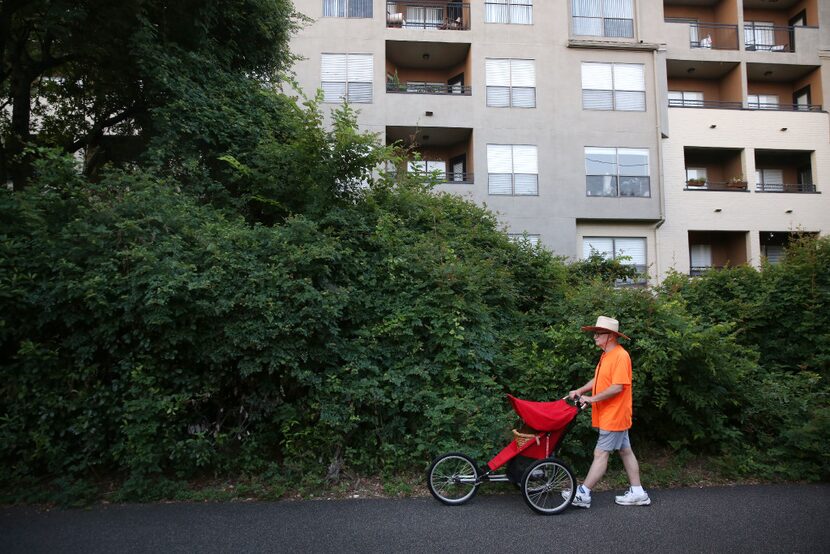 Milt Strong takes a walk with his chicken Summer along the Katy Trail in Dallas.