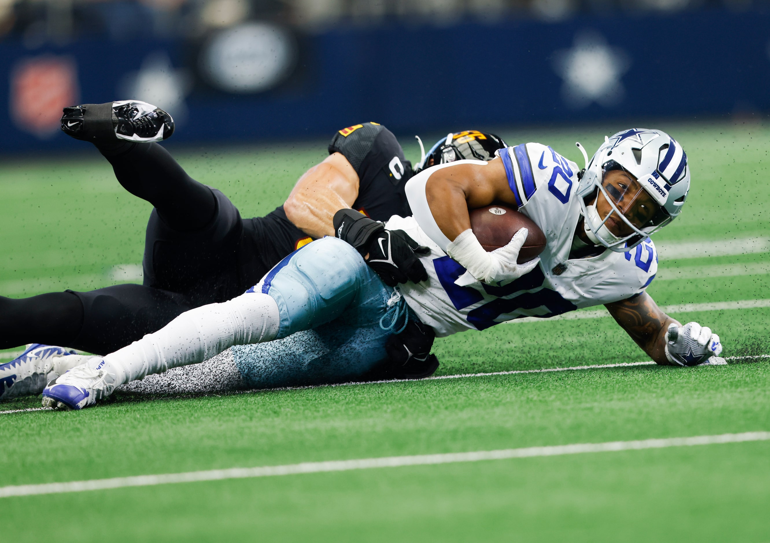 Dallas Cowboys running back Tony Pollard (20) is brought down by Washington Commanders...