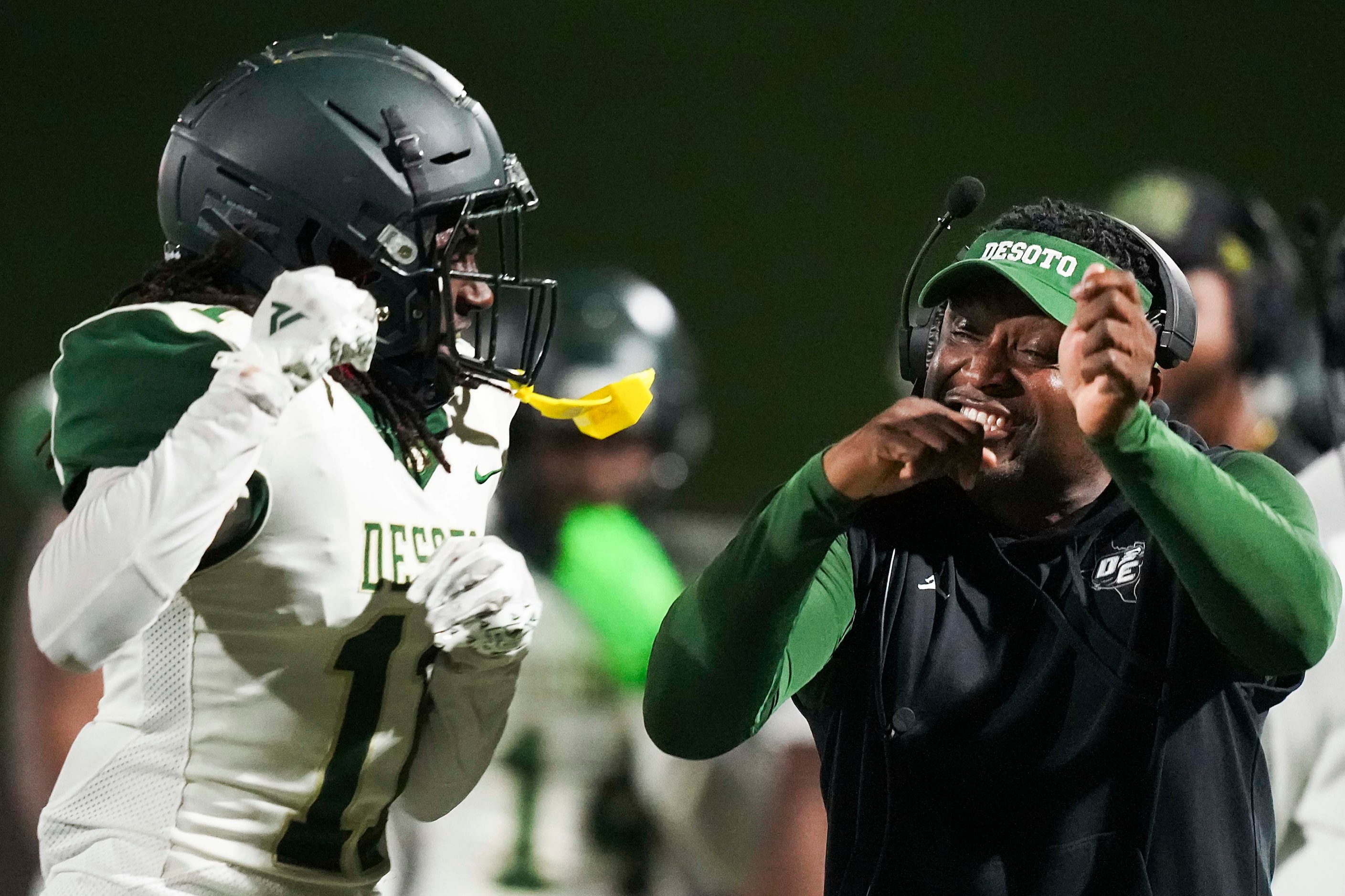 DeSoto head coach Claude Mathis head coach Claude Mathis celebrates with Caleb Holmes (11)...