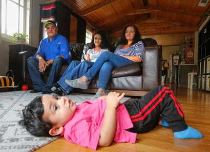 Eighteen-month-old Noah Sosa lies on the floor of a house found through Airbnb, under the...