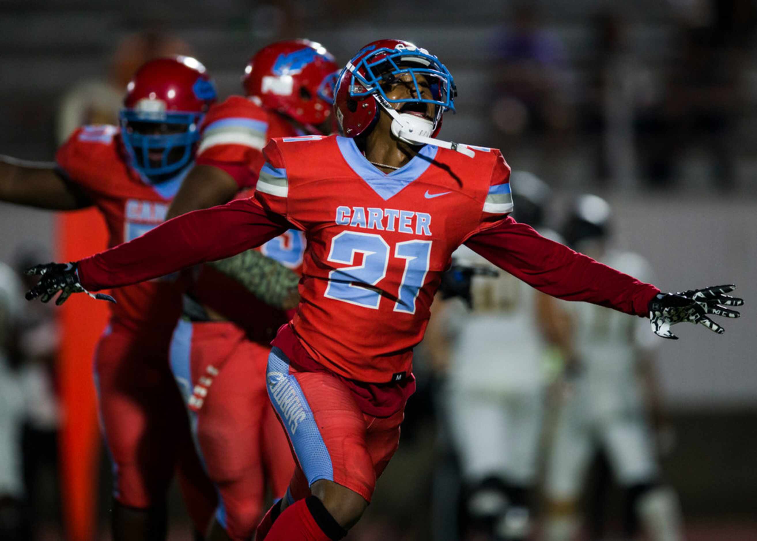 Carter defensive back Dartagnan Walker (21) celebrates after Caleb Jackson (3) caught an...