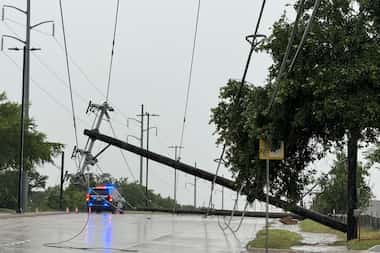 Garland police block traffic due to a downed power line on May 28 in Garland. Strong storms...