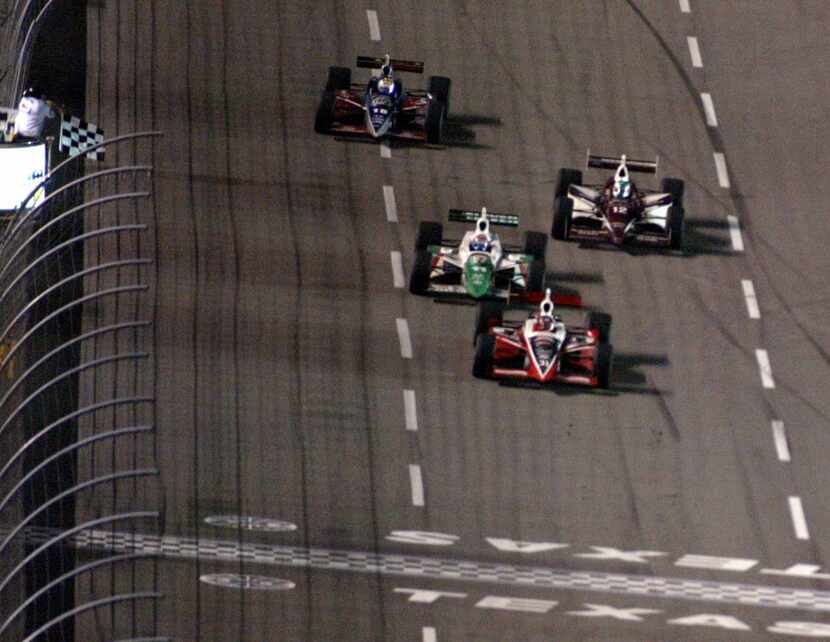 Al Unser Jr. takes the checkered flag in front of #11 Tony Kanaan during the IRL IndyCar...