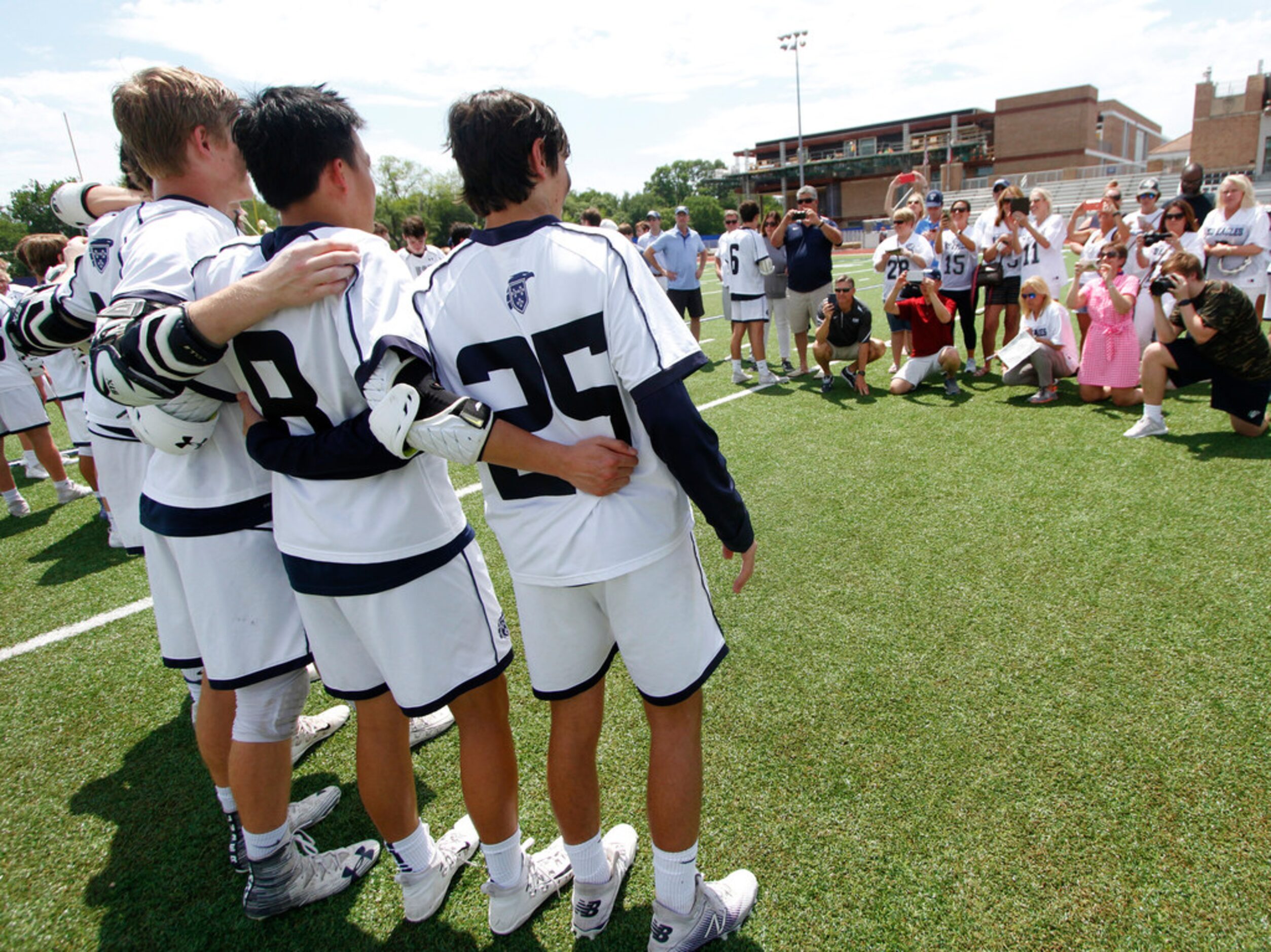 Senior members of the Episcopal School of Dallas lacrosse team pose for fans, family and...