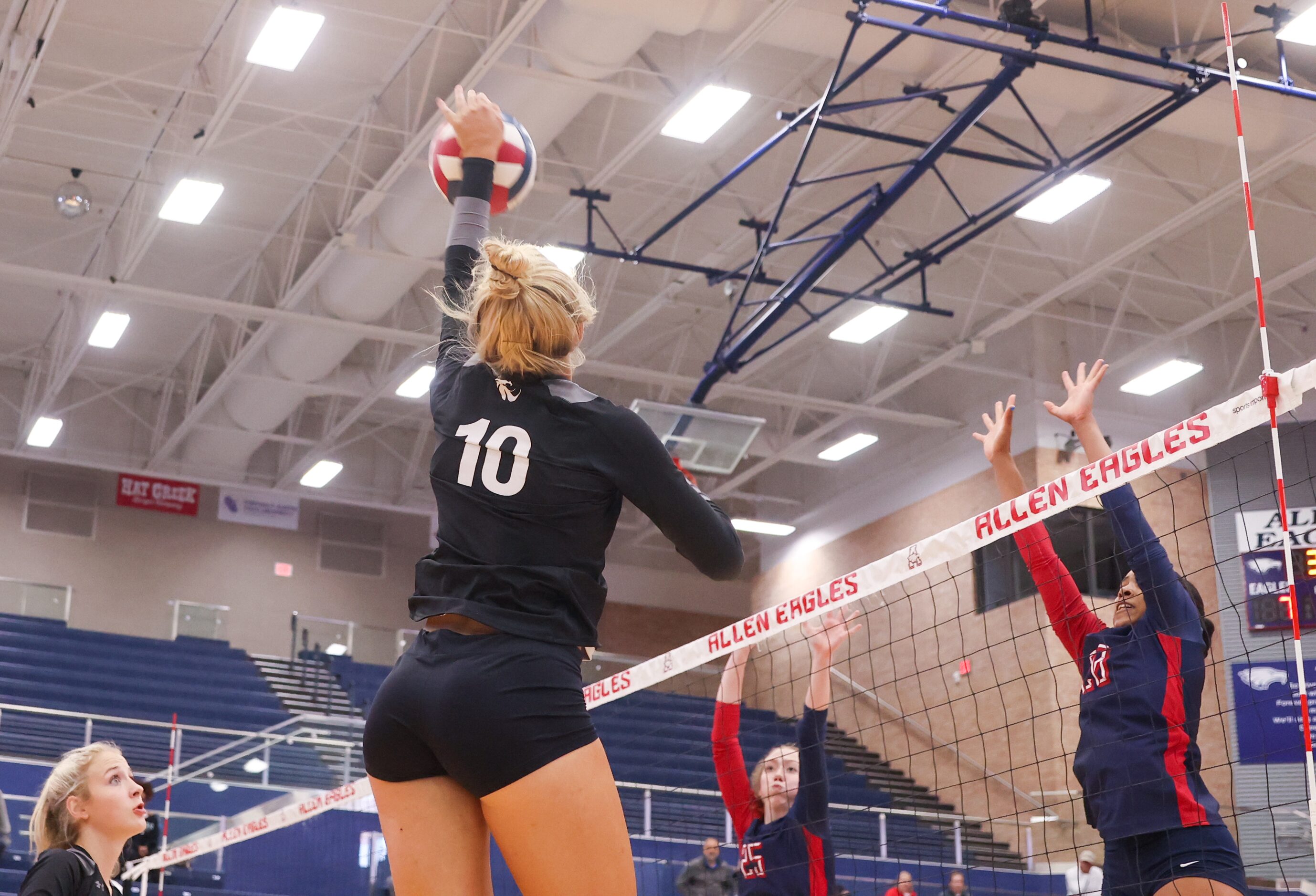 Denton Guyer junior Madelynn Hokanson (10) spikes the ball as Allen sophomore Katelyn Bowman...