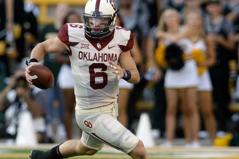 FILE - In this Sept. 23, 2017, file photo, Oklahoma quarterback Baker Mayfield (6) runs...